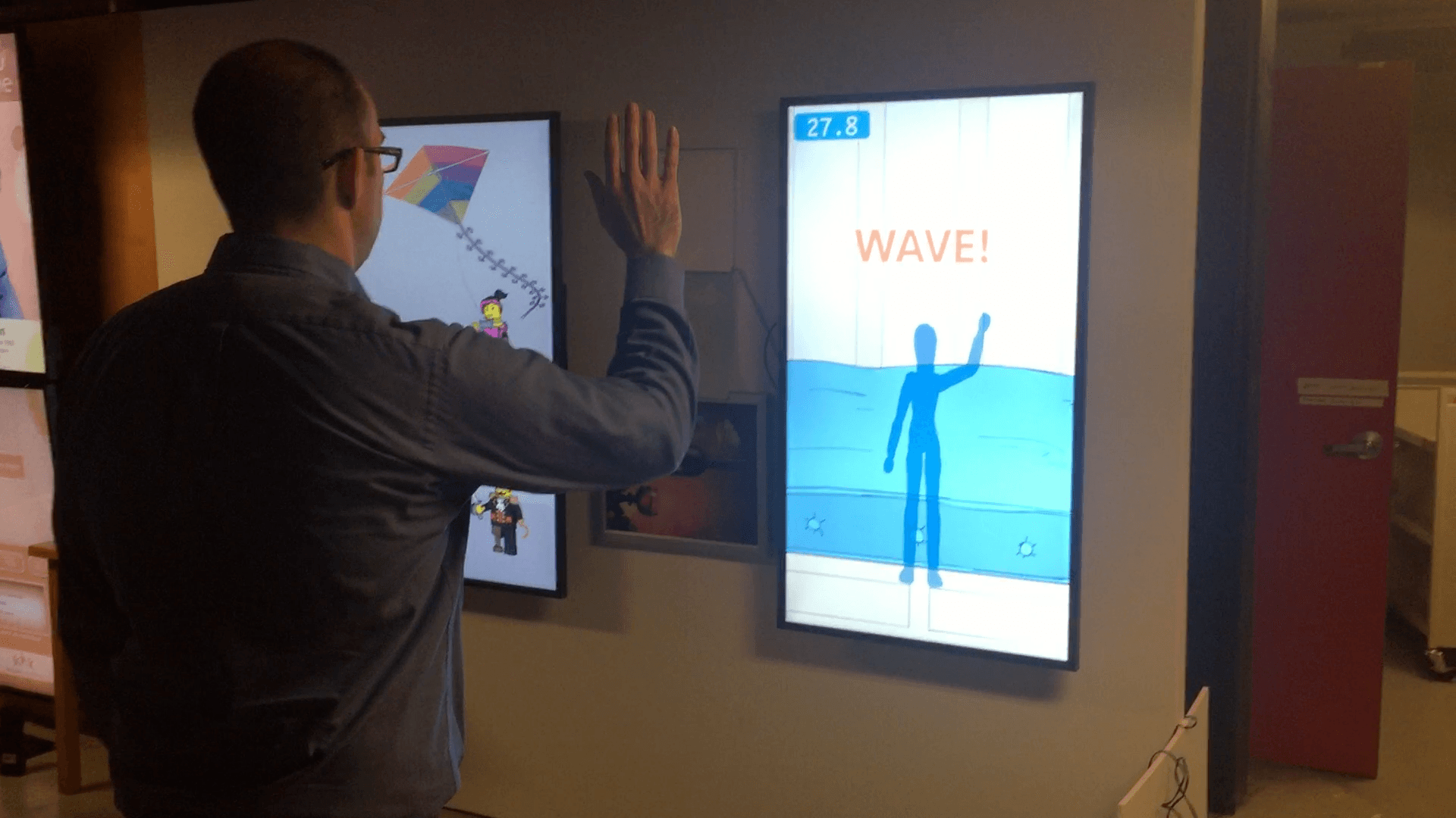 A visitor triggering a motion-reactive installation with gesture.