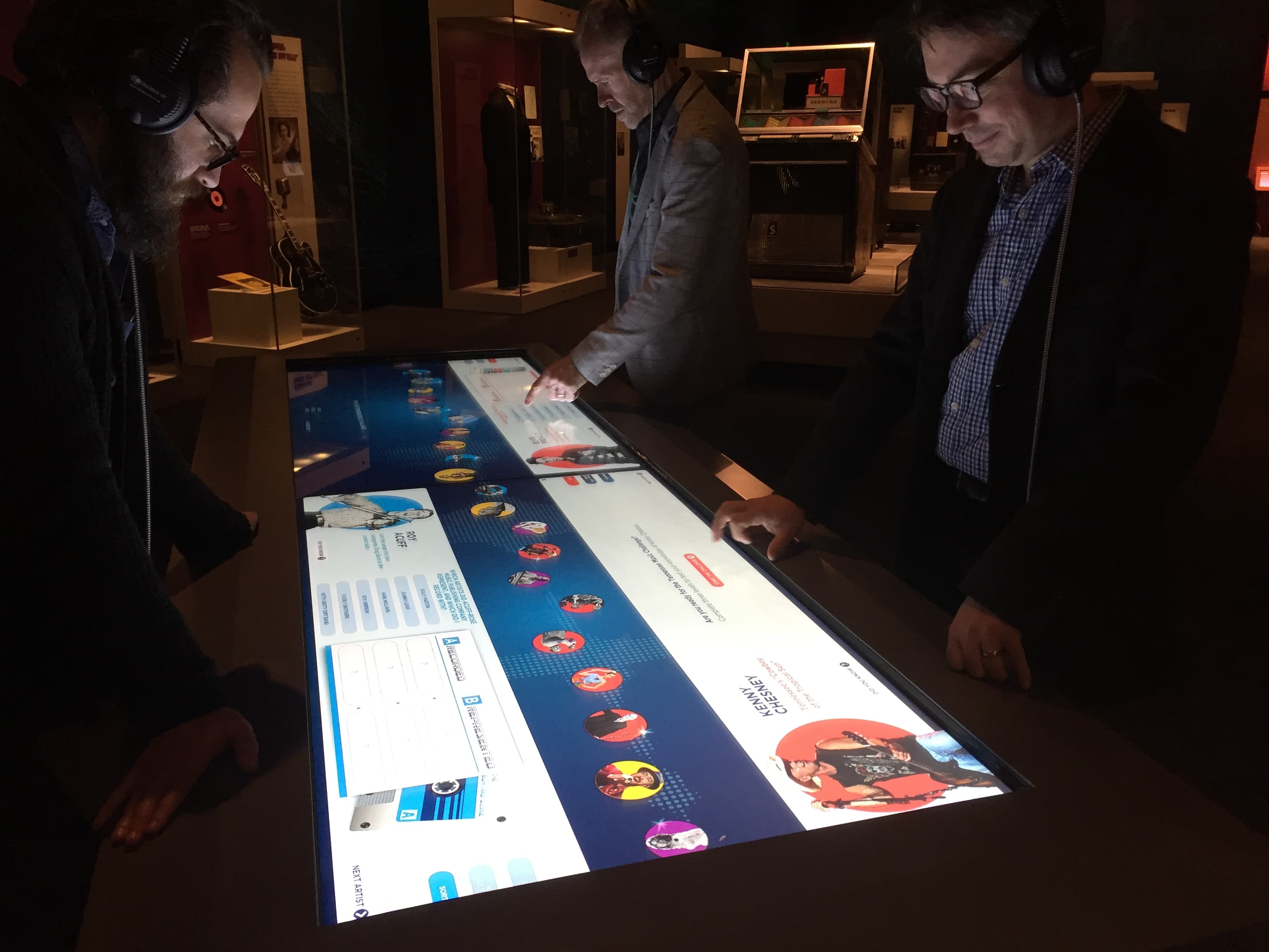 A large-format multi-screen display wall in a gallery.